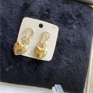 Gold heart earrings with sterling silver posts